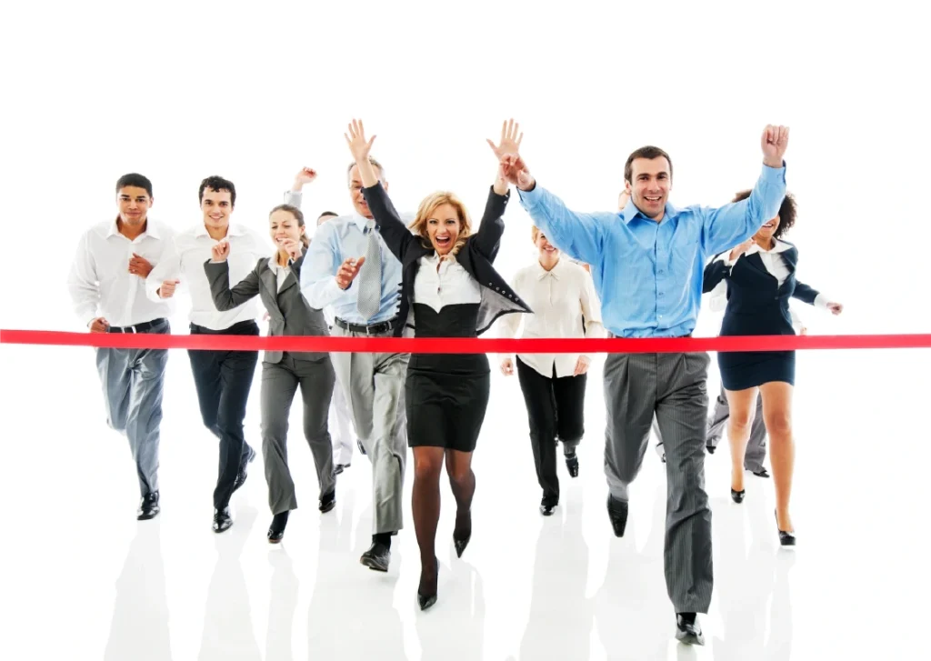 Business professionals cross the finish line